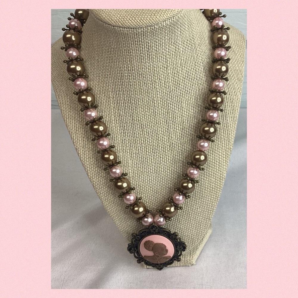 Pink and bronze cameo necklace.
